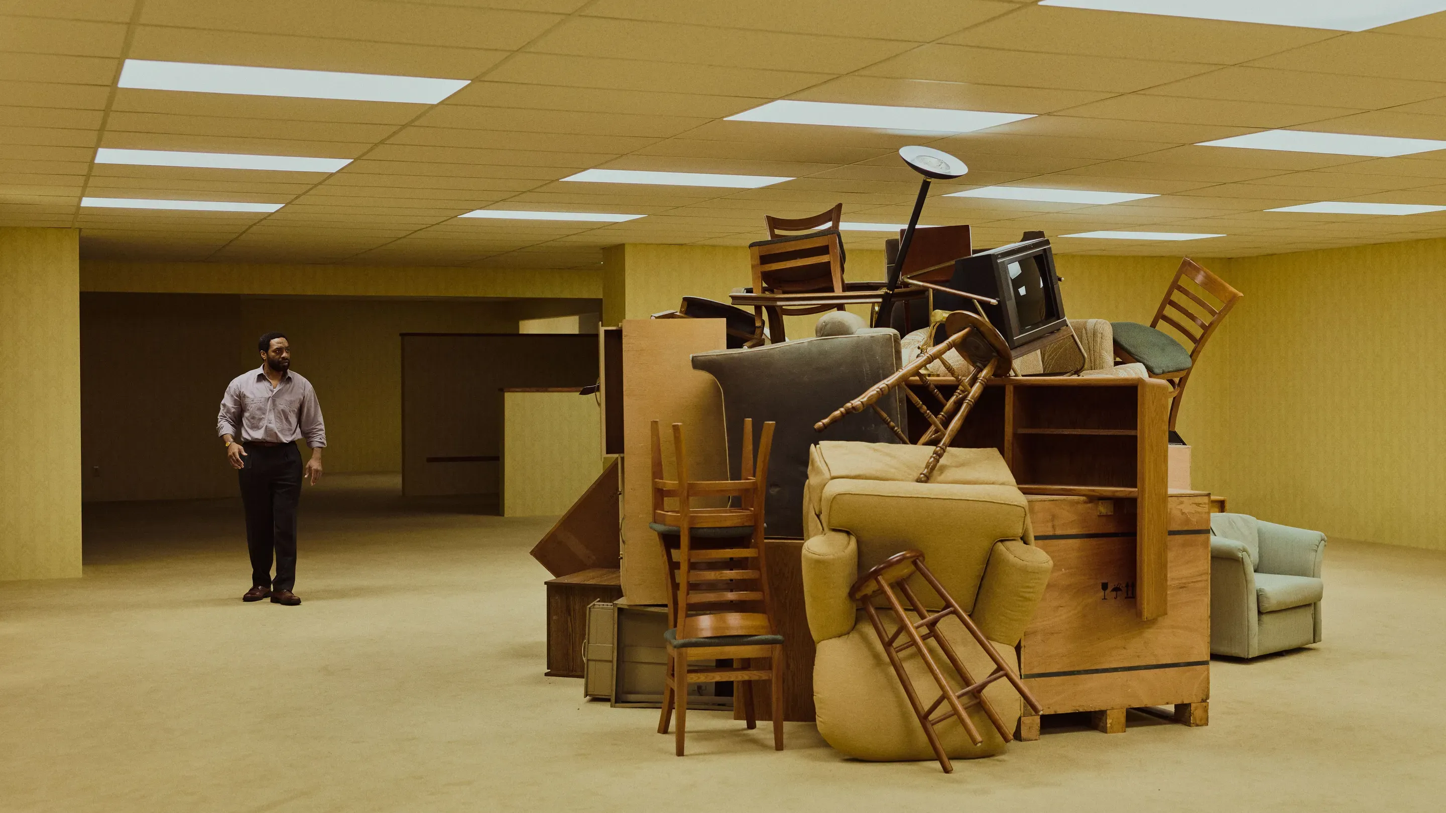 Backrooms film scene grab - furniture heap